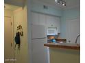 Well-lit kitchen featuring white cabinetry, ample counter space, and modern appliances at 1701 E Colter St # 280, Phoenix, AZ 85016