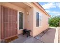 Inviting front porch with security screen door and welcome mat. Bench seating at 17912 N 88Th Dr, Peoria, AZ 85382