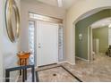 Bright foyer with neutral walls, decorative tile flooring, and a view into other living spaces at 17958 W Udall Dr, Surprise, AZ 85374