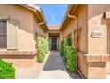 Inviting front entryway with mature green landscaping leading to the front door at 17958 W Udall Dr, Surprise, AZ 85374