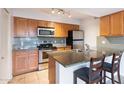 Well-lit kitchen featuring stainless steel appliances, granite countertops, and maple cabinets at 200 E Southern Ave # 222, Tempe, AZ 85282