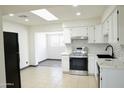Bright kitchen with white cabinets, stainless steel appliances, and modern backsplash at 2902 W Bloomfield Rd, Phoenix, AZ 85029
