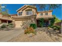 Charming two-story home featuring desert landscaping, a two-car garage, and a welcoming entrance at 31203 N 43Rd St, Cave Creek, AZ 85331