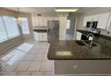 Bright kitchen features white cabinets, stainless steel appliances, and a granite countertop island at 31203 N 43Rd St, Cave Creek, AZ 85331