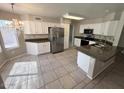 Bright kitchen features white cabinets, stainless steel appliances, and a granite countertop island at 31203 N 43Rd St, Cave Creek, AZ 85331