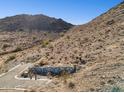 A view showing a desert landscape with a stone wall feature and desert vegetation at 3367 N Highlands Dr # 39, Buckeye, AZ 85396