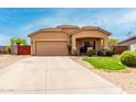 Inviting single-story house with a well-maintained lawn, two-car garage, and a covered porch, offering classic curb appeal at 36064 N Murray Grey Dr, San Tan Valley, AZ 85143