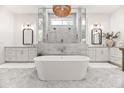 Spa-like bathroom with freestanding tub, marble shower, dual vanities, and elegant fixtures at 3616 N 54Th Pl, Phoenix, AZ 85018