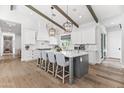 Spacious kitchen boasts white cabinets, a large island, modern lighting, and stainless steel appliances at 3616 N 54Th Pl, Phoenix, AZ 85018