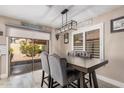 Cozy dining area with modern lighting, gray chairs and a view to the backyard at 4262 E Sundance Ave, Gilbert, AZ 85297