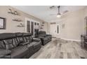 Living area featuring wood-look floors, comfortable seating, and plenty of natural light at 4262 E Sundance Ave, Gilbert, AZ 85297
