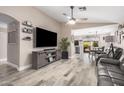 Inviting living room featuring wood-look floors, a ceiling fan and an open floor plan at 4262 E Sundance Ave, Gilbert, AZ 85297