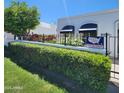 Charming home exterior with manicured hedges, flowers, and awnings offering curb appeal and a welcoming ambiance at 4830 N 72Nd Way, Scottsdale, AZ 85251