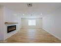 A bright and airy living room features modern floors and an electric fireplace as the focal point at 5627 W Comet Ave, Glendale, AZ 85302
