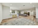 Bright living room, with access to both living areas and light wood floors with area rug at 6002 E Cholla Rd, Cave Creek, AZ 85331