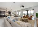Spacious living room with open floor plan, with modern kitchen, dining area and sectional sofa at 6509 W Apex Ave, Queen Creek, AZ 85144