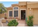Inviting front entrance with a seating area and a well-maintained garden at 6901 W Tonto Dr, Glendale, AZ 85308