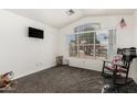 Bright bedroom with a vaulted ceiling, large window, and neutral decor at 7344 E Lindner Cir, Mesa, AZ 85209