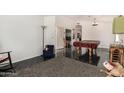 Spacious living room with tile floors and space for a pool table and entertaining at 7344 E Lindner Cir, Mesa, AZ 85209