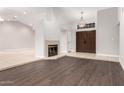 Spacious living room features vaulted ceilings, fireplace, and new hardwood floors at 9009 E Sahuaro Dr, Scottsdale, AZ 85260