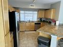 Bright kitchen featuring maple cabinets, granite countertops, stainless appliances, and tile flooring at 1081 W 1St St # 18, Tempe, AZ 85281