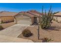 Charming single-story home boasts desert landscaping, tile roof, and a two-car garage at 11004 E Delta Ave, Mesa, AZ 85208