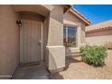 Inviting front entry with a security screen door and neutral stucco exterior at 11004 E Delta Ave, Mesa, AZ 85208