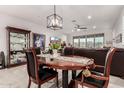 Inviting dining room with modern chandelier and a view into the living room at 13384 W Red Range Way, Peoria, AZ 85383
