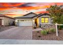 Charming single-Gathering home with a two-car garage, stone accents, and a beautifully landscaped front yard at 13384 W Red Range Way, Peoria, AZ 85383