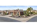 Single-story home with two-car garage, desert landscaping, and manicured lawn at 1588 E Sweet Citrus Dr, Queen Creek, AZ 85140