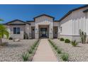 Beautiful home featuring desert landscaping with a walkway to a stylish front entrance at 1845 N 103Rd St, Mesa, AZ 85207