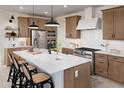 Modern kitchen featuring stainless steel appliances, ample cabinet space, a white tile backsplash, and a large island at 20332 W Sells Dr, Buckeye, AZ 85396