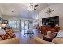 Comfortable living room boasts tile floors, vaulted ceilings, a ceiling fan, and natural light at 2333 E Taxidea Way, Phoenix, AZ 85048