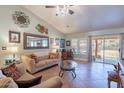 Inviting living room featuring neutral walls, tile flooring, and sliding door to the patio at 2333 E Taxidea Way, Phoenix, AZ 85048