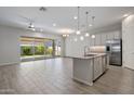 Open-concept living area featuring light-filled interior with tile floors and sliding glass doors to the backyard at 2644 S Dock St, Gilbert, AZ 85295
