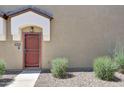 Tan home exterior with a decorative security door and low-maintenance desert landscaping at 2725 E Mine Creek Rd # 2058, Phoenix, AZ 85024