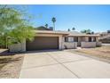 Spacious driveway leading to a two-car garage, complemented by a well-maintained exterior at 3045 W Palmaire Ave, Phoenix, AZ 85051