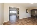 Open-concept living space with wood-look floors and modern lighting fixtures throughout the property at 3045 W Palmaire Ave, Phoenix, AZ 85051