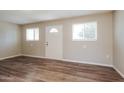 Bright living room with new laminate flooring and natural light from two windows at 3045 W Palmaire Ave, Phoenix, AZ 85051