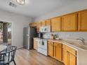 Well-lit kitchen featuring wood cabinets, stainless steel appliances, and a view to the backyard at 3114 S Eugene --, Mesa, AZ 85212