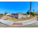 Neighborhood corner with a light gray house behind a block wall on a property with minimal desert landscaping at 3601 N 12Th St, Phoenix, AZ 85014
