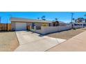 Attractive home showcases a modern exterior with a clean driveway, a mix of fencing and privacy walls, and low-maintenance landscaping at 3601 N 12Th St, Phoenix, AZ 85014
