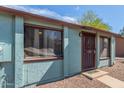 Close-up of a cozy home exterior showing the front door and window details at 3645 N 69Th Ave # 12, Phoenix, AZ 85033