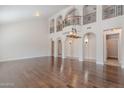 Open-concept living room boasting high ceilings, dark wood floors, arched doorways, and a wrought iron balcony at 514 E Pearce Rd, Phoenix, AZ 85042