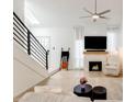 Inviting living room with fireplace, fan, and lots of natural light from the staircase skylight at 5350 N 3Rd Ave, Phoenix, AZ 85013