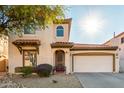 Charming two-story home featuring stucco siding, a terracotta roof, a two-car garage, and low maintenance desert landscaping at 5423 W Range Mule Dr, Phoenix, AZ 85083