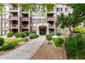 Inviting condo building facade with stone accents and a well-maintained landscaped entrance at 5450 E Deer Valley Dr # 3003, Phoenix, AZ 85054