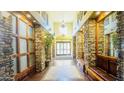 Grand hallway with decorative stone pillars, tiled floors, and seating, leading to glass doors at 5450 E Deer Valley Dr # 3003, Phoenix, AZ 85054