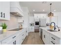 Stylish kitchen featuring a sleek stainless-steel refrigerator and a bright white color palette at 6514 W Apex Ave, Queen Creek, AZ 85144