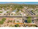 Expansive aerial view of a residential neighborhood, showcasing mature trees and mountain views at 6610 N 15Th Ave, Phoenix, AZ 85015
